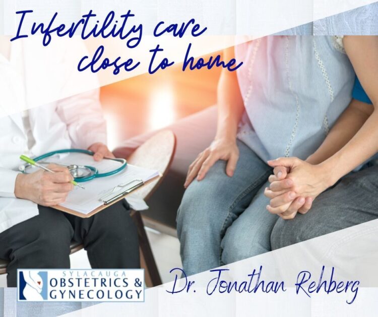 Doctor holding a pad consults with a couple that is holding hands