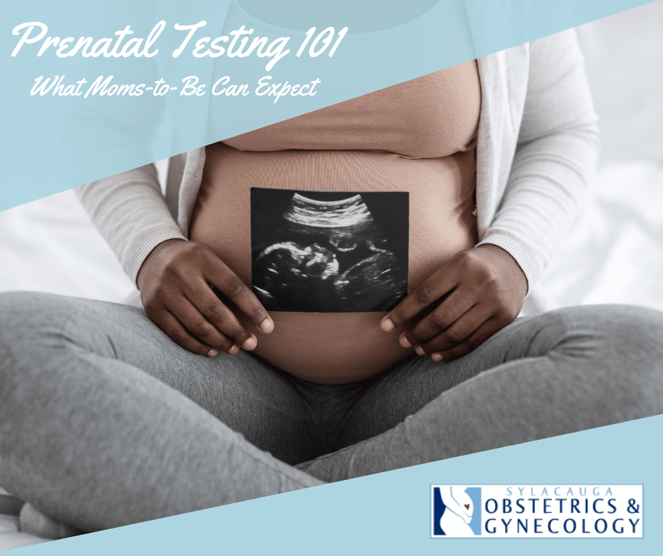 Shoulders-down view of pregnant woman sitting cross-legged on a bed, holding a sonogram picture.